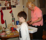 Carole with grandson making cookies at Christmas time.
