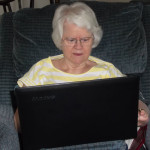Connected Carole writing on her laptop while resting in her recliner.