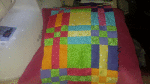 Quilted pillow. Pinks, blues, greens, oranges.
