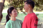 Woman in green shirt facing man in red shirt. Both are smiling and happy.