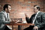 Two men having coffee and discussion.