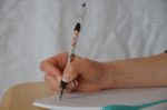 hand putting pen to paper