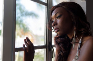 Sad woman looking out window