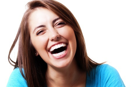 Pretty young woman laughing.
