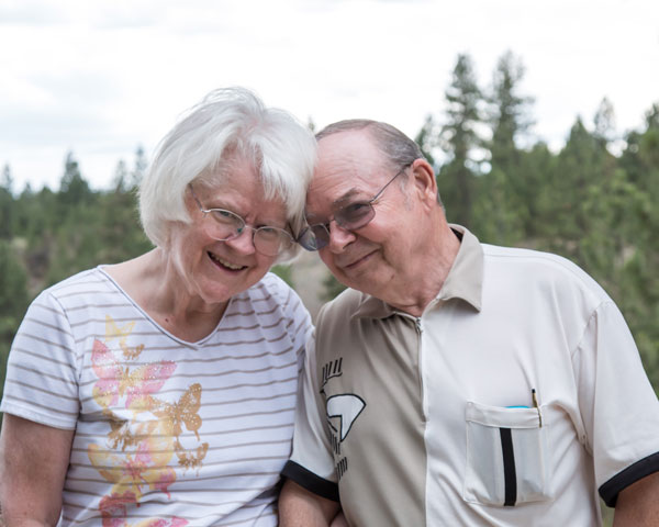 Carole and Joe, laughing, head-to-head at their 50th