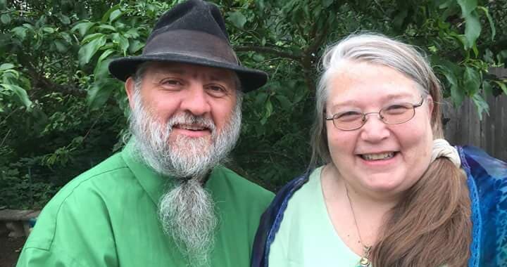 John and Lynn Reader, both dressed in green.