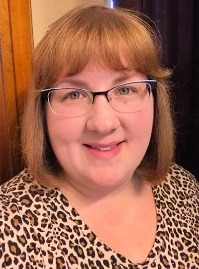 Becky Kluckner, guest writer, woman with brown hair, glasses, and wearing leopard print blouse.