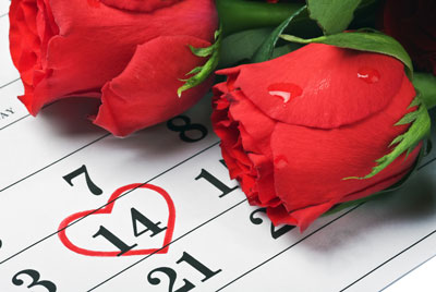 Febreary calendar with the 14th circled with a red heart. Red roses at the side.
